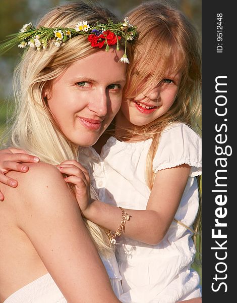Mother and daughter outdoors portrait
