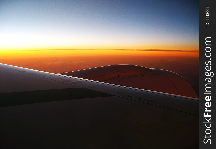 Sunset on the wing of the plane