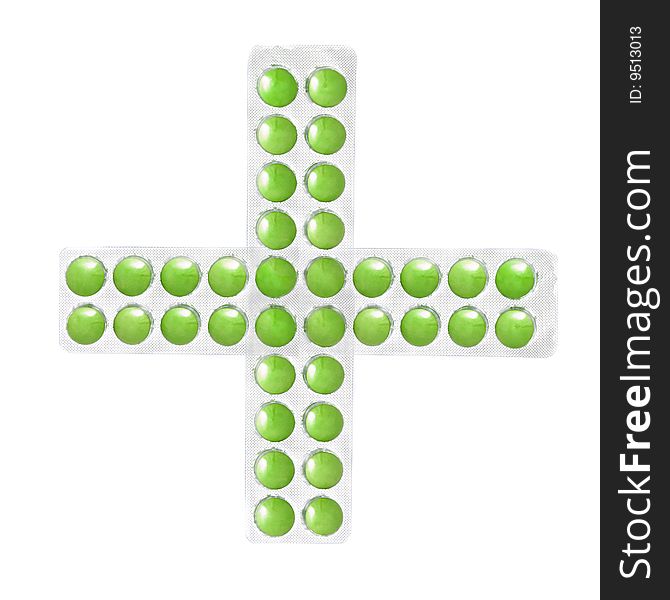 Cross from packs of green tablets isolated on white