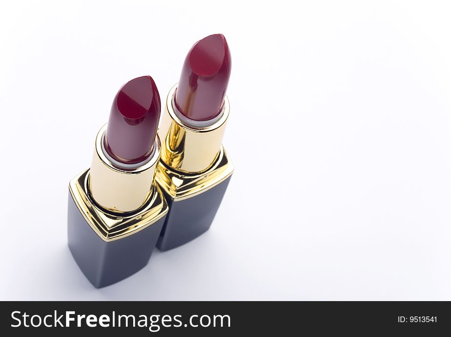 Pair of red lipstick on white background. Pair of red lipstick on white background