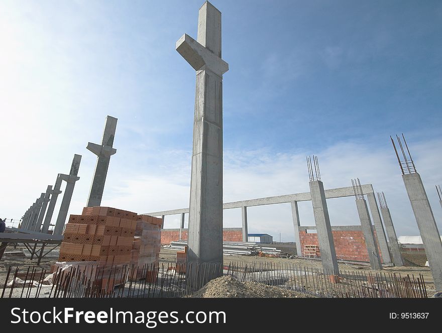 Construction site with enforced steel concrete pillions rising up