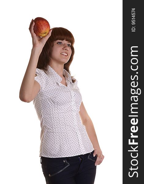 The young red girl holds an apple on a white background. The young red girl holds an apple on a white background