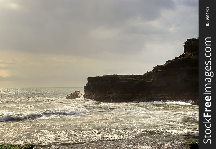 Bali island rocky coast at sunset in stormy weather