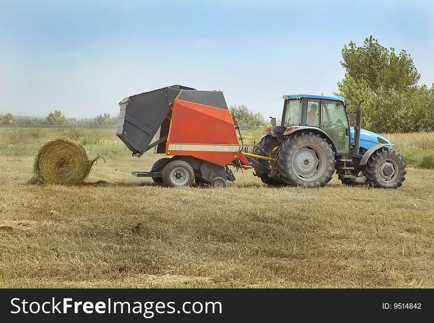 Tractor plowing field of grain