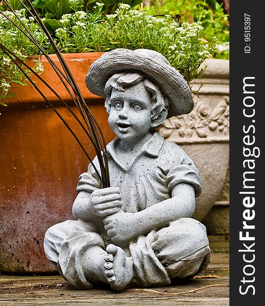 Pottery statue of boy fishing