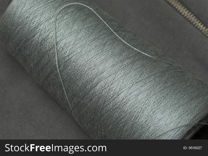Zip dark grey textile with the thread. Zip dark grey textile with the thread