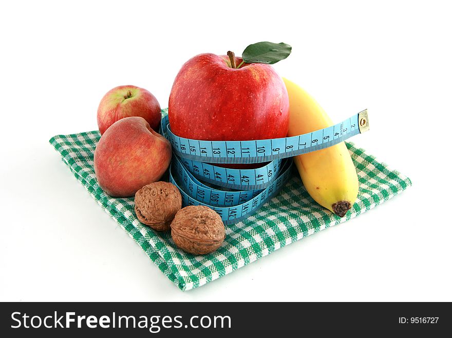 Fresh fruits, walnut and tape measure isolated on white background. Fresh fruits, walnut and tape measure isolated on white background.