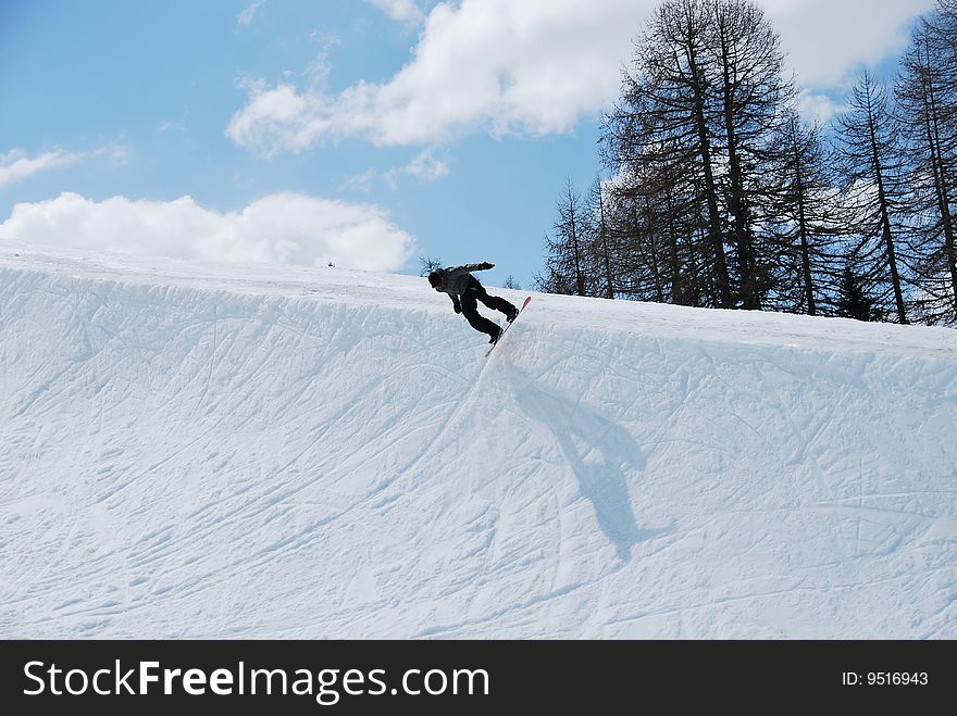 Snowboarder jump in a half-pipe. Snowboarder jump in a half-pipe