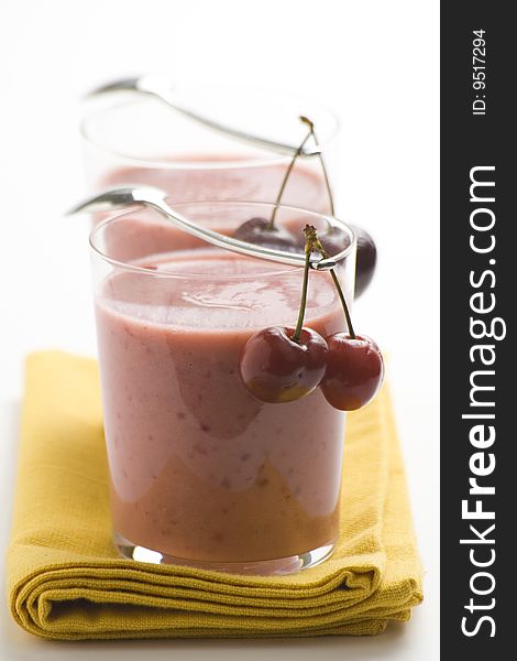 A delicious cherry milkshake isolated over white