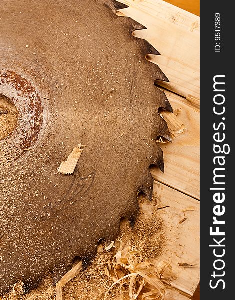 Tool series: circular saw on wooden table with sawdust