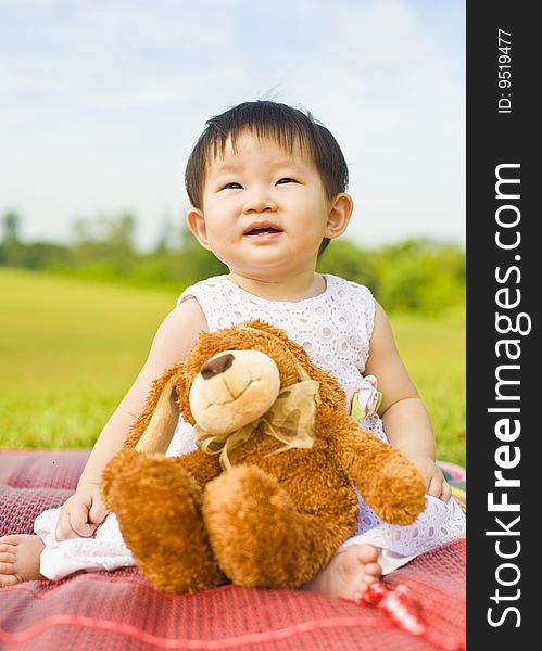 Portrait Of A Infant Girl Outdoor In The Park