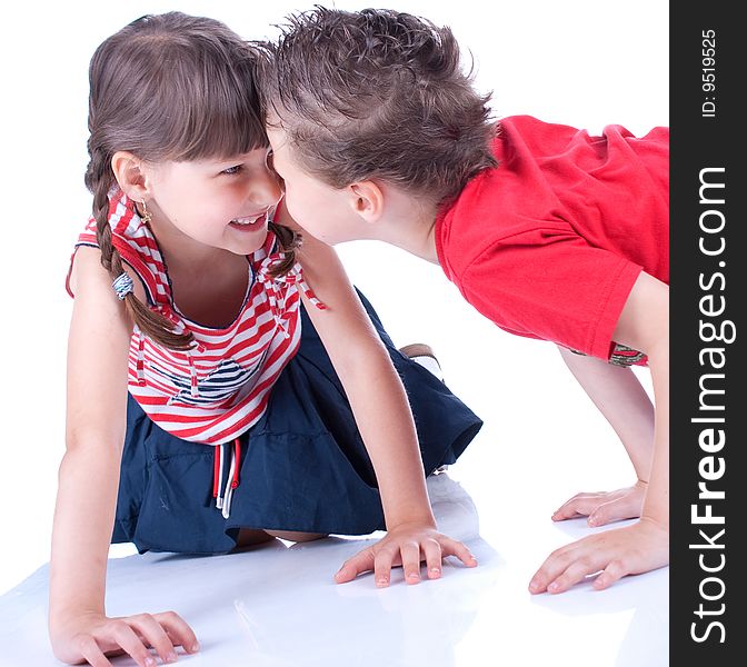 Cute blue-eyed boy and girl are playing , stidio shot