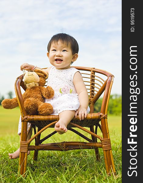 Portrait of an asian infant girl taken outdoors in an open park. Portrait of an asian infant girl taken outdoors in an open park
