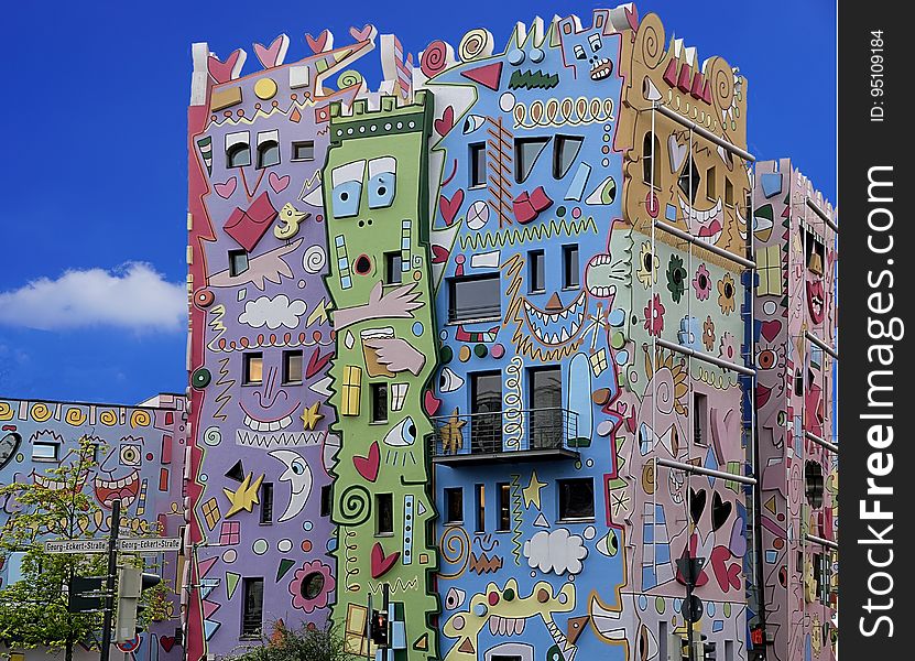 A building decorated with brightly coloured graffiti. A building decorated with brightly coloured graffiti.