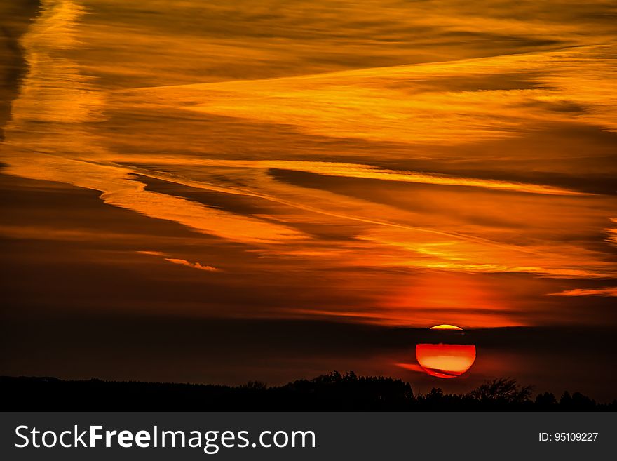 A beautiful, dramatic sunset with clouds filtering the colour.