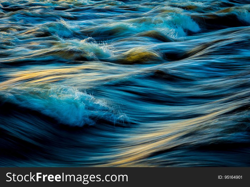 Turbulent waves photographed in long exposure.