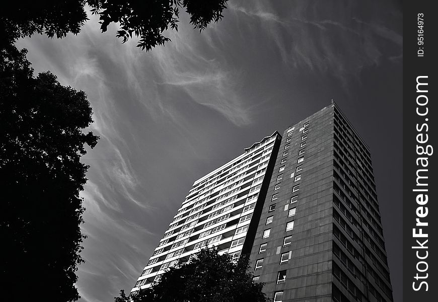 A black and white photo of an apartment block building.