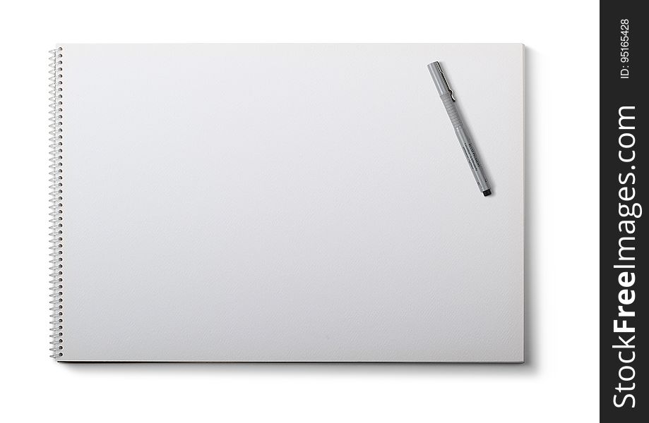 A white spiral notebook page and a pen on top. A white spiral notebook page and a pen on top.