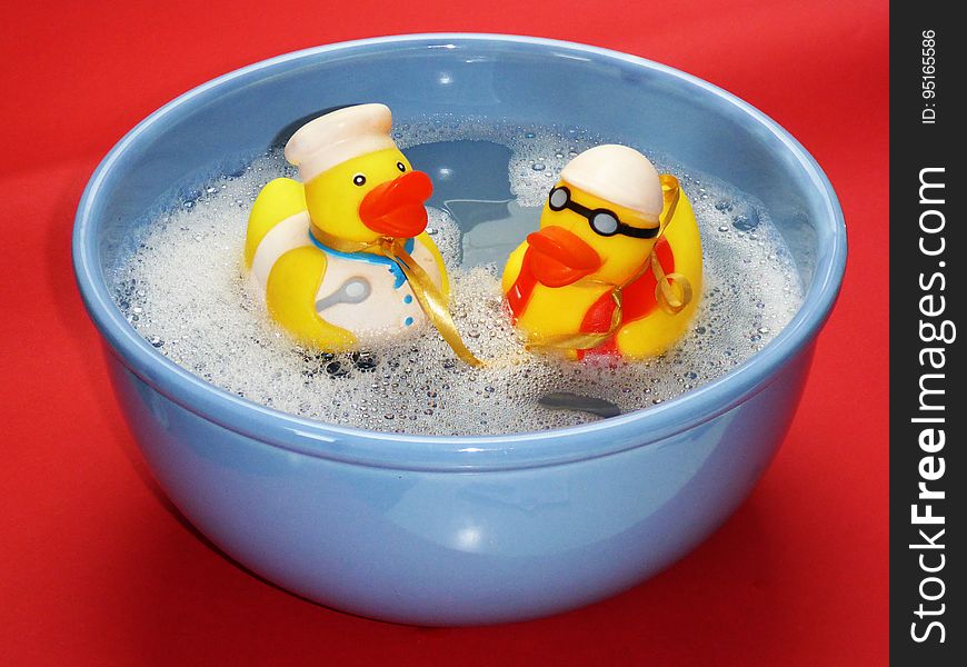 2 Rubber Ducky On Blue Ceramic Bowl