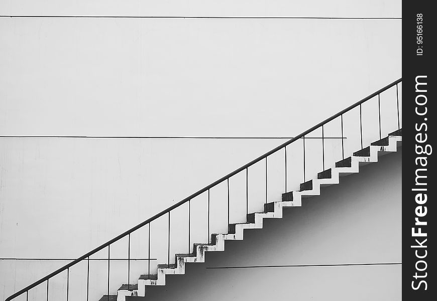 A staircase against a white wall.