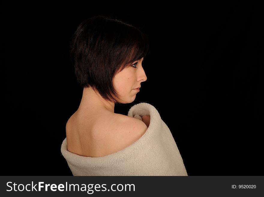 A formal portrait of a dark haired teenage girl. Black background. A formal portrait of a dark haired teenage girl. Black background