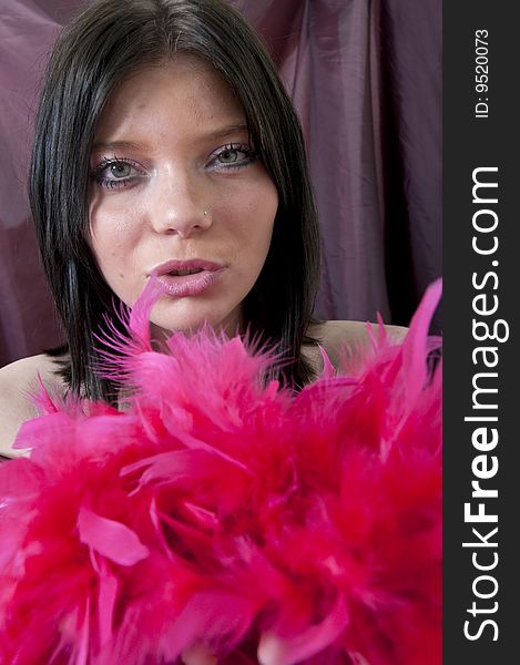 Girl posing with red feathers