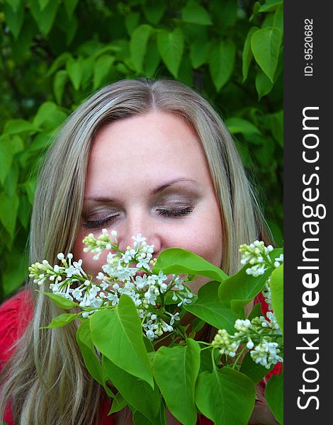 Young girl and blossoming lilac