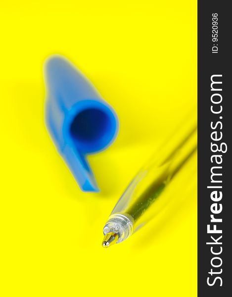 Ball point pens isolated against a yellow background