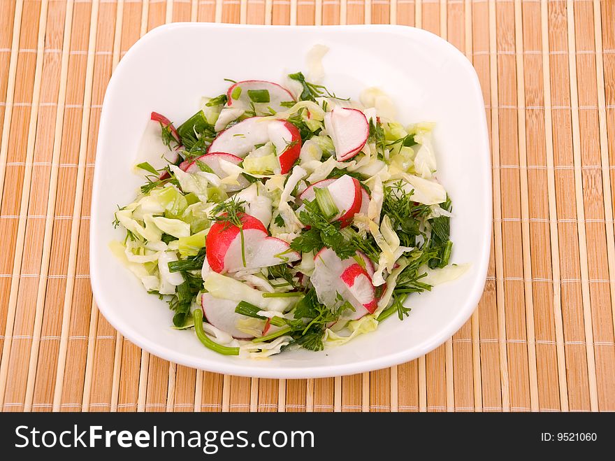 Fresh green salad with cabbage, a garden radish and greens