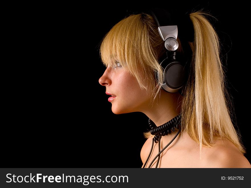 Profile of a young beautiful girl in headphones. Profile of a young beautiful girl in headphones