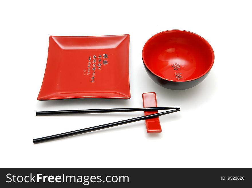 Square red plate, round bowl and chopsticks on stand. Square red plate, round bowl and chopsticks on stand