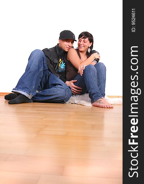 Young couple in hiphop / emo style sitting on the floor barefeet. Isolated over white. Young couple in hiphop / emo style sitting on the floor barefeet. Isolated over white.