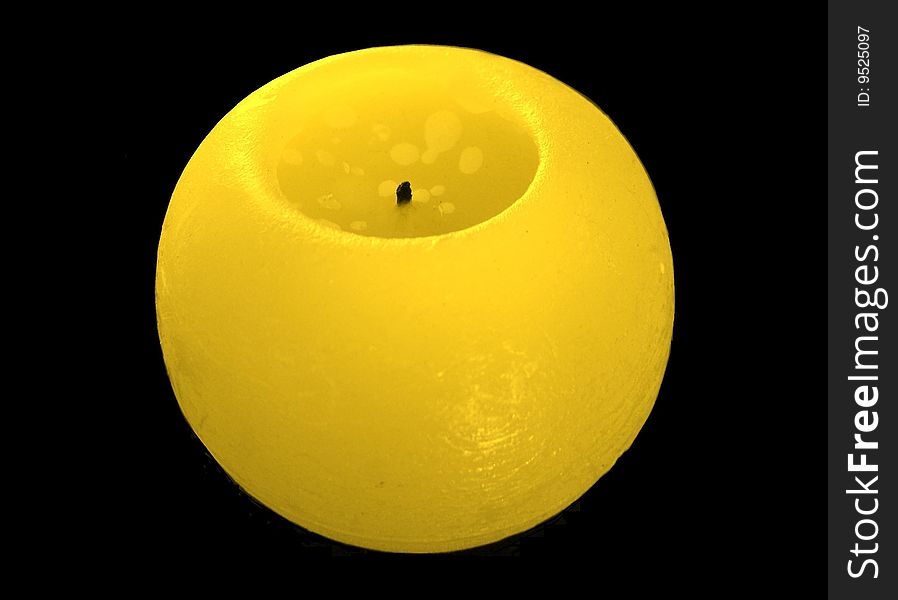 Yellow round candle on a black background. Yellow round candle on a black background