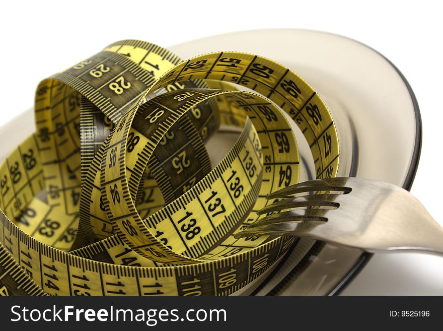 Plate and fork with measuring tape isolated on white. Plate and fork with measuring tape isolated on white