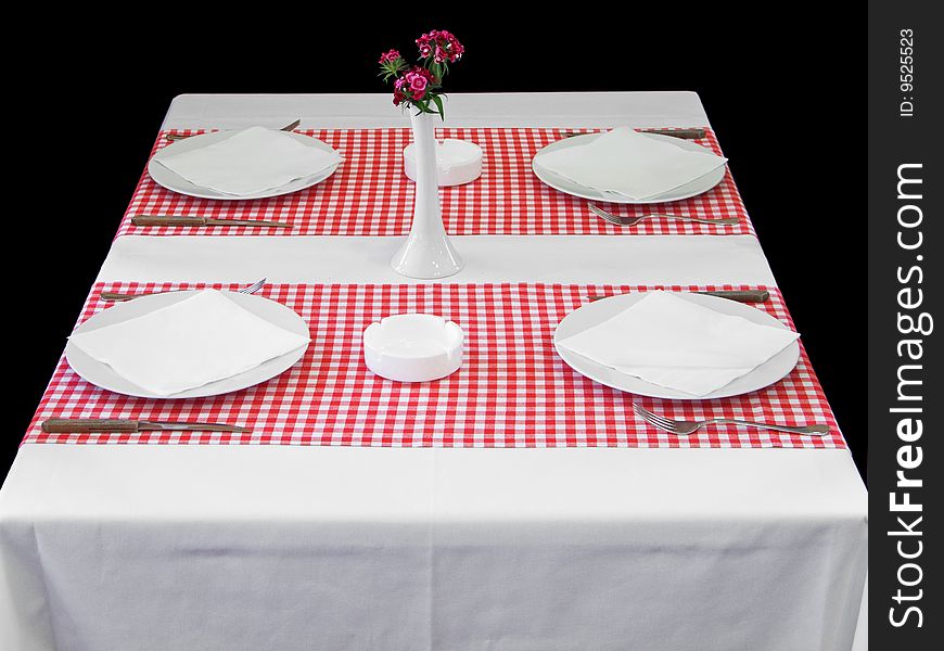 Plaits with silverware on table with red checked tablecloth. Plaits with silverware on table with red checked tablecloth