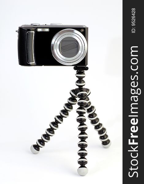 Black digital camera on a flexible tripod. Black digital camera on a flexible tripod.