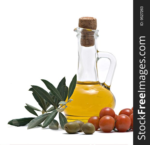 Bottle of olive oi, tomatoes, and olive fruits