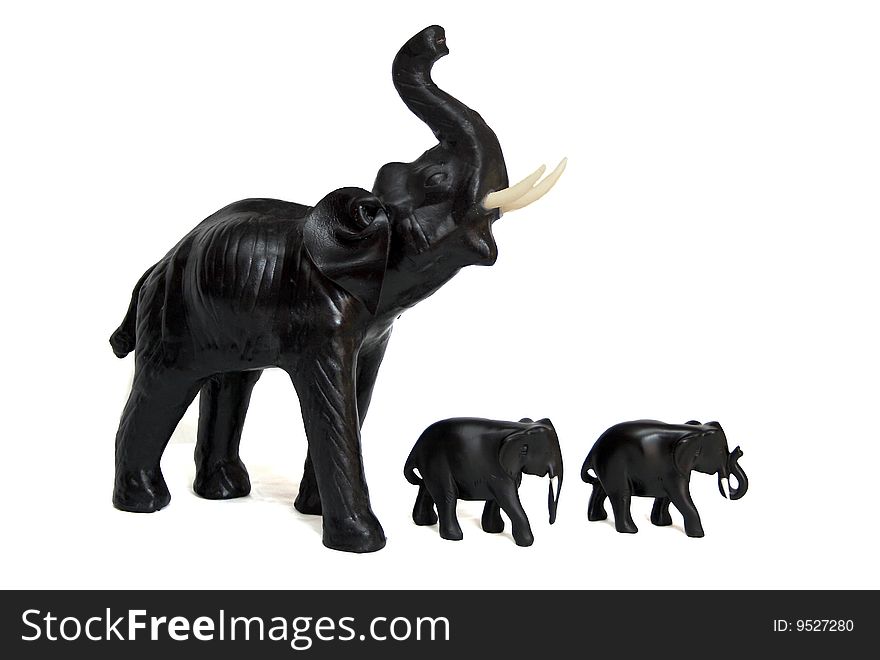 Three wooden toy elephants on a white background