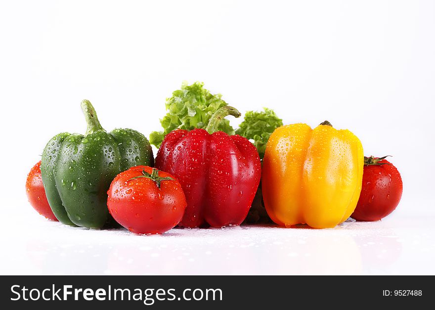 Fresh tomatoes and pepper on a white background. Fresh tomatoes and pepper on a white background
