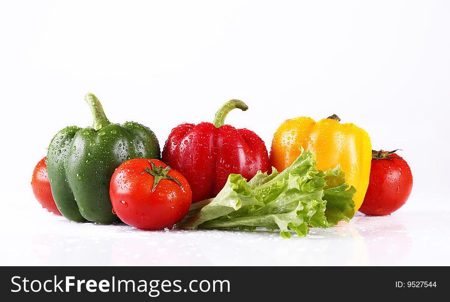 Fresh tomatoes and pepper on a white background. Fresh tomatoes and pepper on a white background