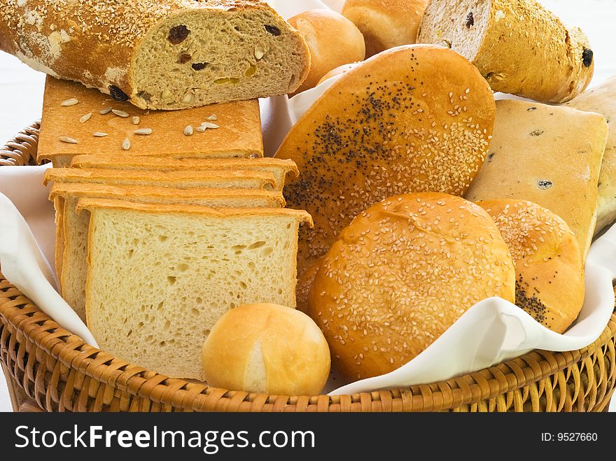 A variety of freshly baked bread in a basket. A variety of freshly baked bread in a basket