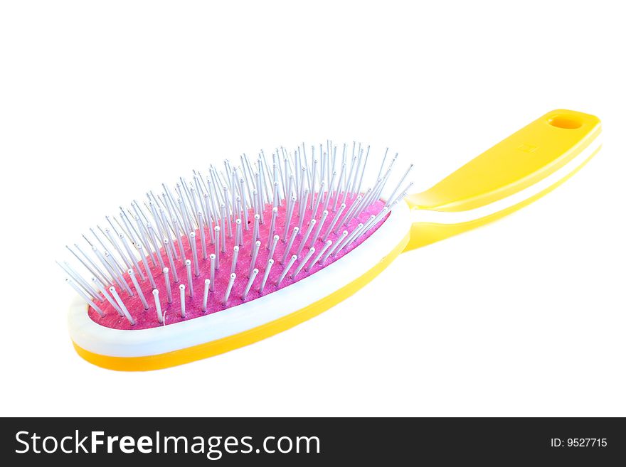 Yellow hairbrush on a white background, it is isolated.
