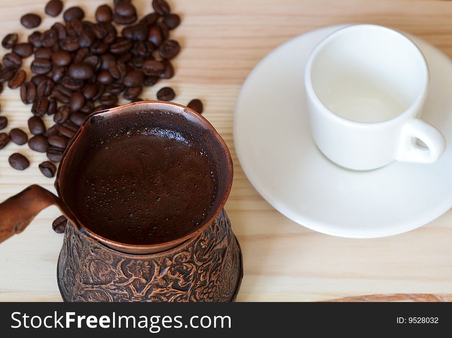 Original turkish coffee with coffee beans on wooden background