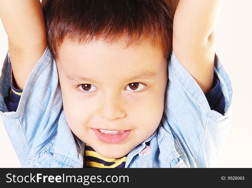 Photo of adorable young boy raising hands. Over white Background