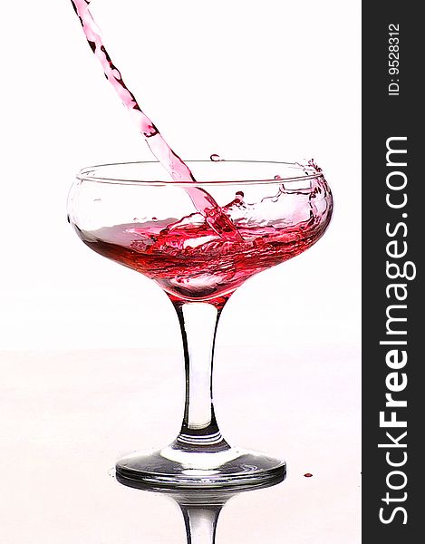 The wine flowing in a glass water  drop drops. The wine flowing in a glass water  drop drops