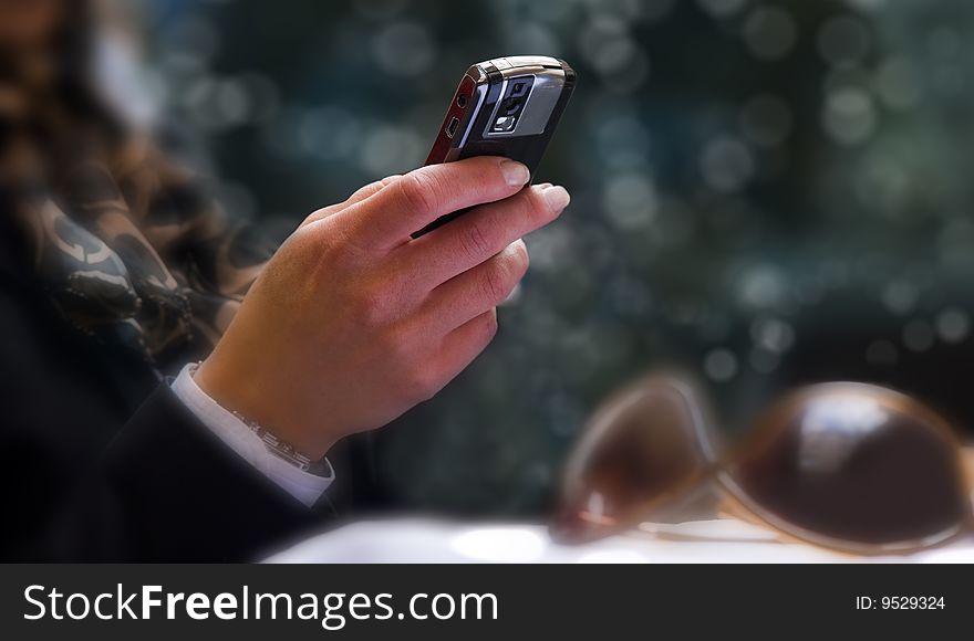 Closeup of a womens hand using a cellphone. Closeup of a womens hand using a cellphone