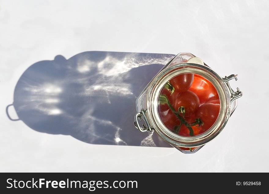 Food series: red ripe cherry tomato in jar