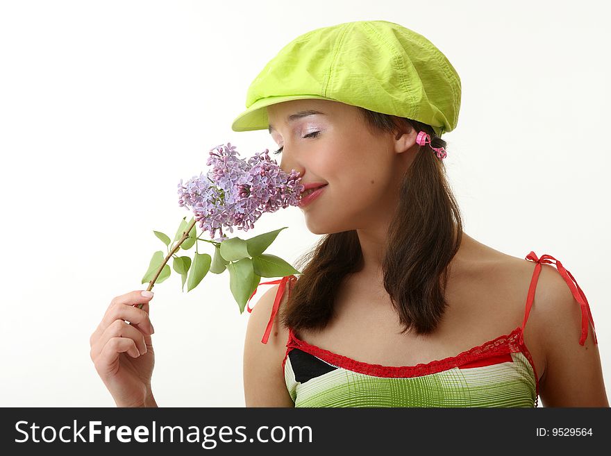 The girl in a green cap with a lilac bouquet