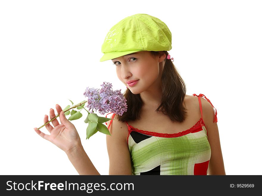 The girl in a green cap with a lilac bouquet