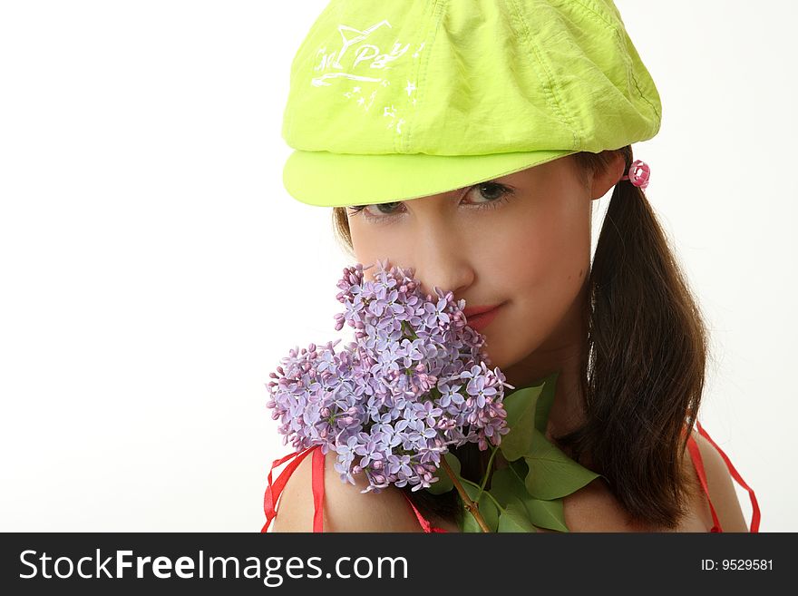 The girl in a green cap with a lilac bouquet